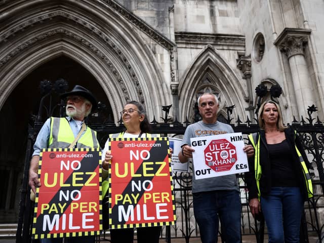 Demonstrators protest against the expansion of the Ultra Low Emission Zone (ULEZ), outside the Royal Courts of Justice in July. (Photo by HENRY NICHOLLS/AFP via Getty Images)