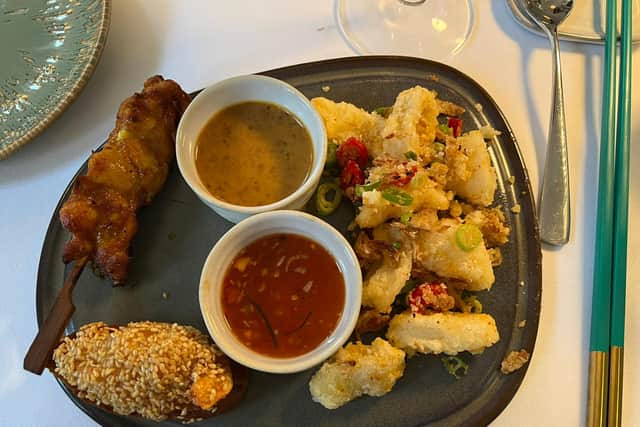 Trio of crispy fried salt and pepper squid, sesame prawn toast with a lime coriander dip and a corn-fed chicken satay skewer with peanut sauce