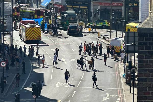A large cordon is in place on Peckham High Street after a pedestrian died in a collision with a lorry. Credit: LondonWorld.