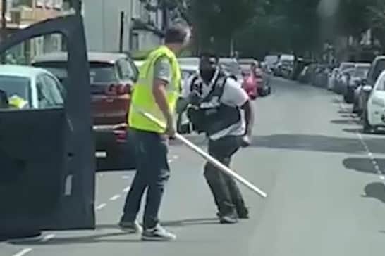 Shocking footage shows a daylight street brawl between a disgruntled driver - and a traffic warden. (Photo via SWNS)
