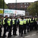 Police officers patrol during the main parade of the Notting Hill Carnival. Credit: Henry Nicholls/AFP via Getty Images.