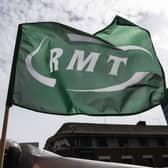 A RMT flag flies at a picket line outside Euston Station. Credit: Hollie Adams/Getty Images.