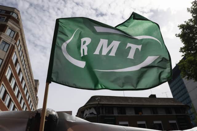 A RMT flag flies at a picket line outside Euston Station. Credit: Hollie Adams/Getty Images.