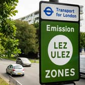 Vehicles pass by a sign indicating the new boundary of the LEZ and ULEZ expansion on August 29. Credit: Leon Neal/Getty Images.