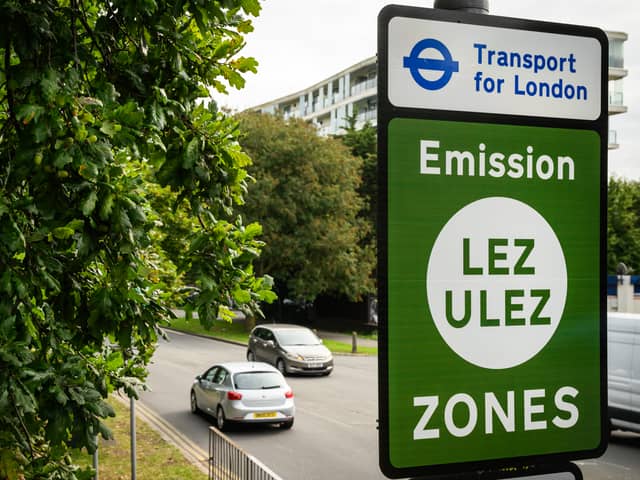 Vehicles pass by a sign indicating the new boundary of the LEZ and ULEZ expansion on August 29. Credit: Leon Neal/Getty Images.