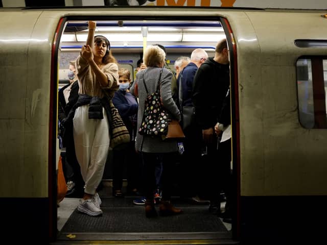 Commuters packed onto a busy Tube train.