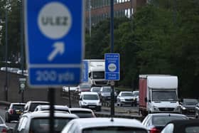 Traffic passes a sign indicating the ULEZ near Hanger Lane in west London. Credit: Justin Tallis/AFP via Getty Images.