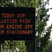 A sign advising motorists to turn off their vehicle engines when in stationary traffic, due to the high levels of pollution, on side of the A4 heading out of central London. Credit: Justin Tallis/AFP via Getty Images.