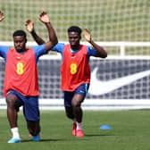  Marc Guehi and Bukayo Saka of England stretch during a training session at St Georges Park (Photo by Catherine Ivill/Getty Images)