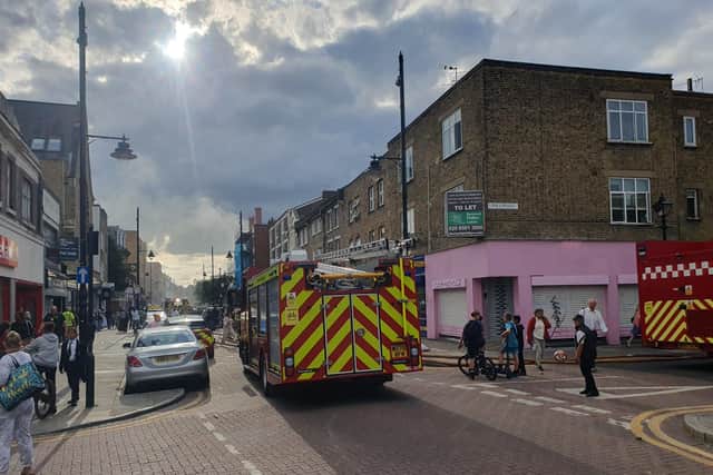 Ground floor shop with homes above it alight in east London