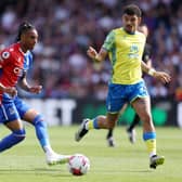  Michael Olise of Crystal Palace holds the ball whilst under pressure from Morgan Gibbs-White . (Photo by Richard Heathcote/Getty Images)