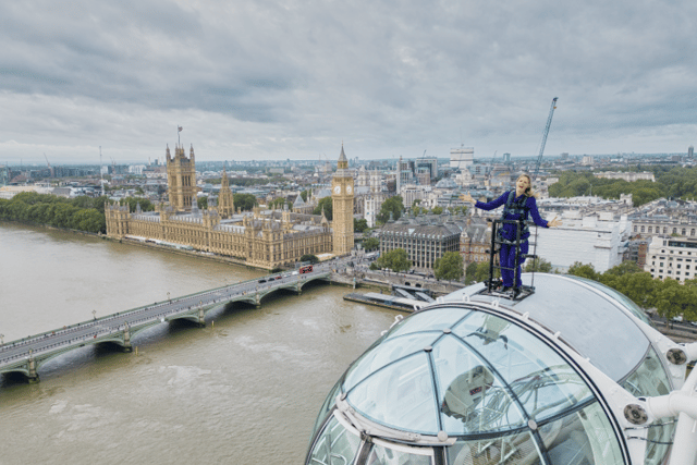 ITV News’s Sally Williams reports the weather from atop the London Eye. (Photo by Lastminute London Eye)
