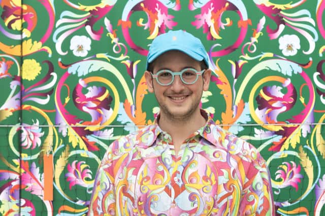 Adam Nathaniel Furman stands with their installation at Queer Nature, Kew Gardens 