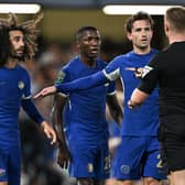 Marc Cucurella, Moises Caicedo and Ben Chilwell of Chelsea surround the referee during the Carabao Cup Third Round match (Photo by Mike Hewitt/Getty Images)