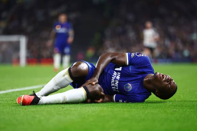 Moises Caicedo of Chelsea goes down with an injury during the Premier League match between Fulham FC  (Photo by Bryn Lennon/Getty Images)