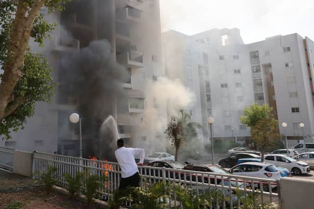 An Israeli youth runs for cover during shelling in Ashkelon as barrages of rockets are fired from the Gaza Strip into Israel on October 7, 2023. Credit: AFP via Getty Images