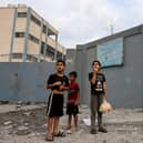  Palestinian children react to the sound of an Israeli airstrike on Gaza City on October 9, 2023