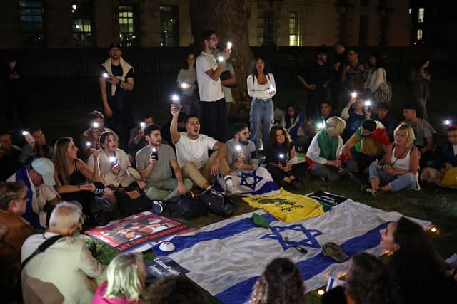 People take part in a 'Vigil for Israel' opposite the entrance to Downing Street, the official residence of Britain's prime minister. Credit: Henry Nicholls/AFP via Getty Images.