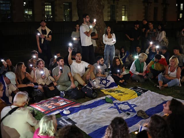 People take part in a 'Vigil for Israel' opposite the entrance to Downing Street, the official residence of Britain's prime minister. Credit: Henry Nicholls/AFP via Getty Images.