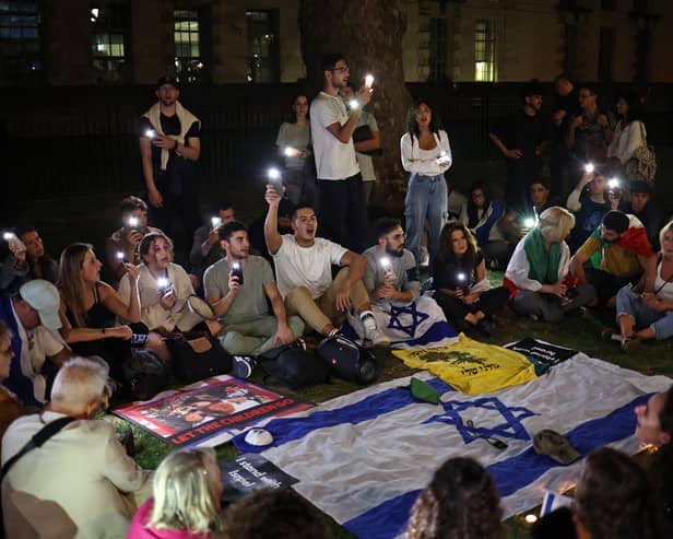 People take part in a 'Vigil for Israel' opposite the entrance to Downing Street, the official residence of Britain's prime minister. Credit: Henry Nicholls/AFP via Getty Images.