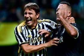 Juventus' former Italian players Antonio Conte (L) and Angelo Di Livio (R) share a laugh during a football match (Photo by MARCO BERTORELLO/AFP via Getty Images)