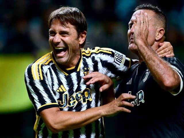 Juventus' former Italian players Antonio Conte (L) and Angelo Di Livio (R) share a laugh during a football match (Photo by MARCO BERTORELLO/AFP via Getty Images)