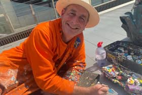 Ben Wilson at work on his chewing gum trail of pictures on the Millennium Bridge. Credit: Freya Cumming.