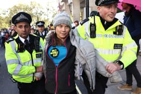 Swedish climate activist Greta Thunberg is arrested by police outside the InterContinental London Park Lane during the “Oily Money Out” demonstration. Credit: Henry Nicholls/AFP via Getty Images.