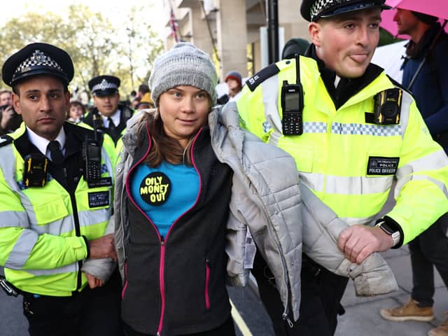 Swedish climate activist Greta Thunberg is arrested by police outside the InterContinental London Park Lane during the “Oily Money Out” demonstration. Credit: Henry Nicholls/AFP via Getty Images.