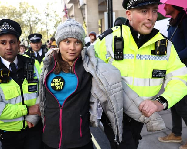 Swedish climate activist Greta Thunberg is arrested by police outside the InterContinental London Park Lane during the “Oily Money Out” demonstration. Credit: Henry Nicholls/AFP via Getty Images.