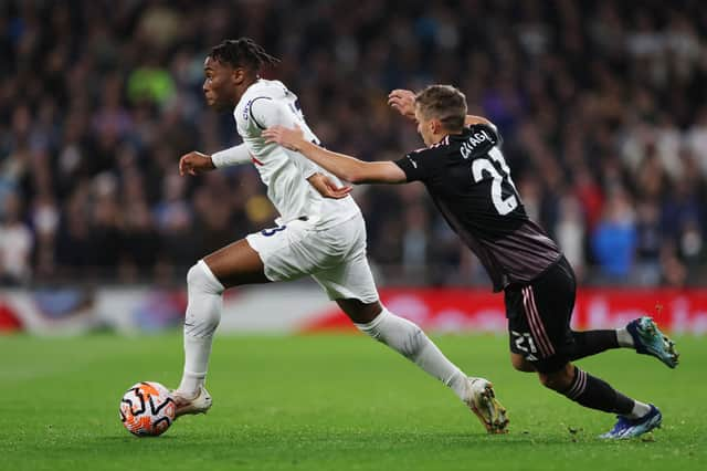 Destiny Udogie of Tottenham Hotspur runs with the ball whilst under pressure from Timothy Castagne of Fulham. (Photo by Alex Pantling/Getty Images)