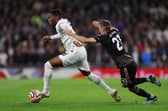 Destiny Udogie of Tottenham Hotspur runs with the ball whilst under pressure from Timothy Castagne of Fulham. (Photo by Alex Pantling/Getty Images)