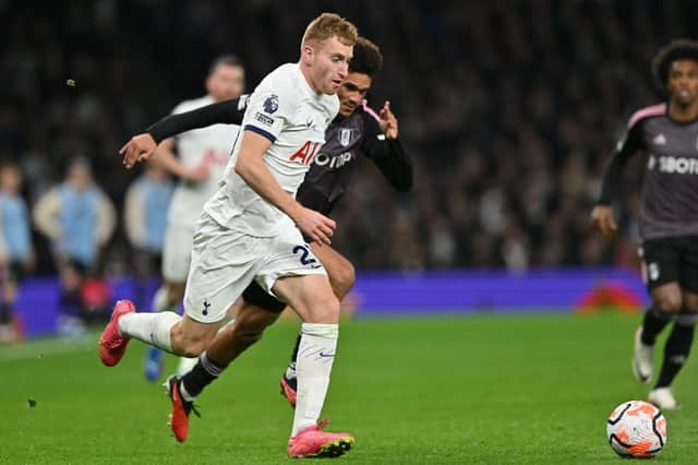 Tottenham Hotspur's Swedish midfielder Dejan Kulusevski holds off Fulham's Antonee Robinson. (Photo by GLYN KIRK/AFP via Getty Images)