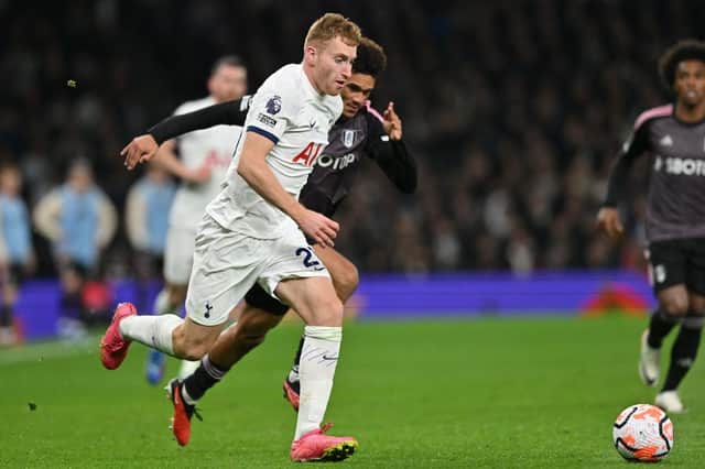 Tottenham Hotspur’s Swedish midfielder #21 Dejan Kulusevski runs away from Fulham’s English-born  (Photo by GLYN KIRK/AFP via Getty Images)
