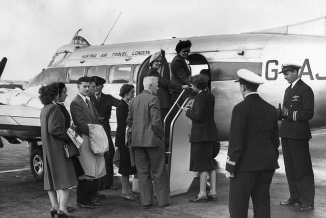 Tourists board a passenger plane at Croydon Airport, south London, bound for Jersey. Credit: Reg Speller/Fox Photos/Getty Images.