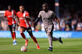 Yves Bissouma of Tottenham Hotspur runs with the ball whilst under pressure from Jacob Brown of Luton Town . (Photo by Marc Atkins/Getty Images)