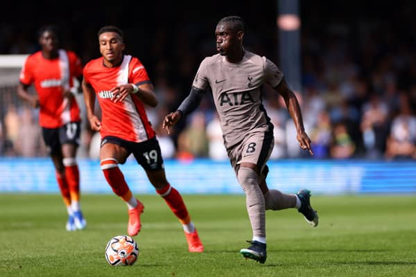 Yves Bissouma of Tottenham Hotspur runs with the ball whilst under pressure from Jacob Brown of Luton Town . (Photo by Marc Atkins/Getty Images)