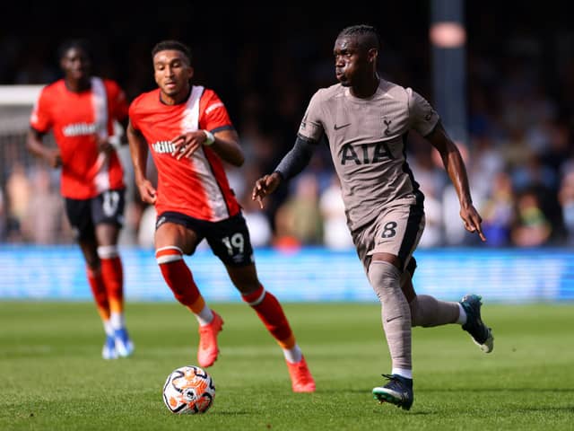 Yves Bissouma of Tottenham Hotspur runs with the ball whilst under pressure from Jacob Brown of Luton Town . (Photo by Marc Atkins/Getty Images)