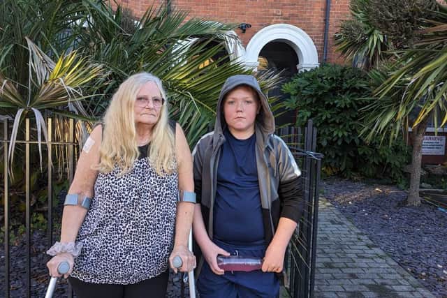 Rosemary Boden and her grandson outside her temporary accommodation in Lower Addiscombe. (Photo by Harrison Galliven)