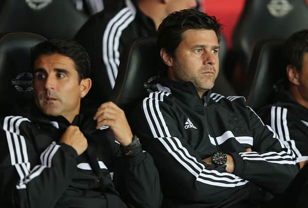 Manager Mauricio Pochettino (R) of Southampton and assistant manager Jesus Perez look on (Photo by Ian Walton/Getty Images)