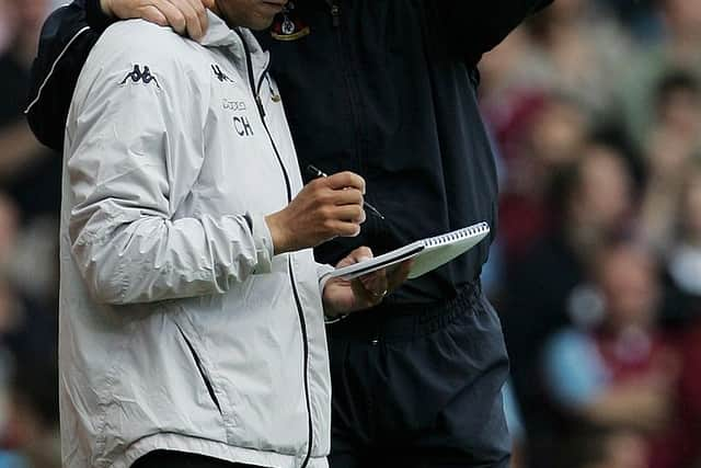   Martin Jol manager of Tottenham Hotspur talks to coach Chris Hughton during the Barclays Premiership match between West Ham United   (Photo by Phil Cole/Getty Images)