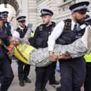 Met Police officers remove a Just Stop Oil protester detained whilse blocking Whitehall during a protest (Photo: Lucy North/PA Wire)