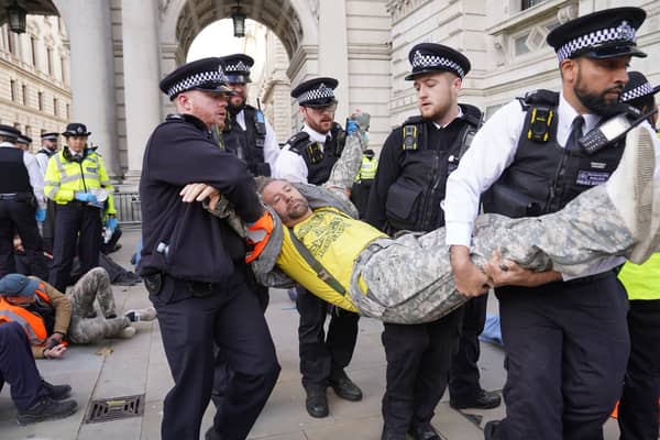 Met Police officers remove a Just Stop Oil protester detained whilse blocking Whitehall during a protest (Photo: Lucy North/PA Wire)