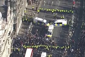 Officers have detained a large group of counter protestors in Bridge Street on Armistice Day. (Photo by MPS) 