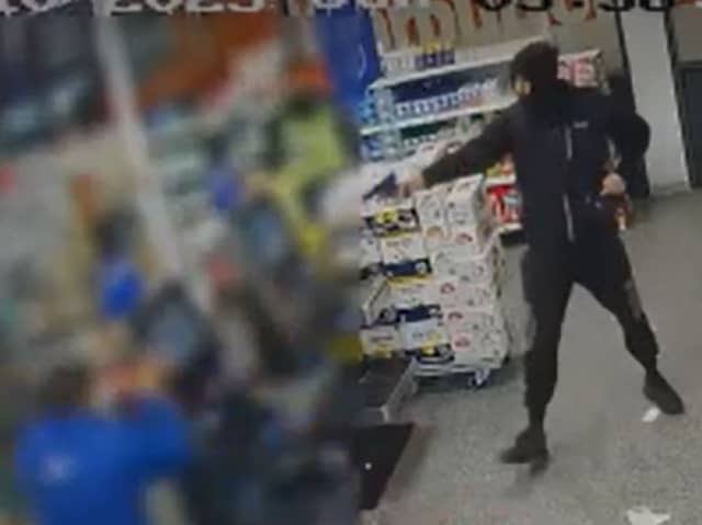 An armed robber in the Tesco store in Camden Road. (Photo by MPS)