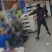An armed robber in the Tesco store in Camden Road. (Photo by MPS)
