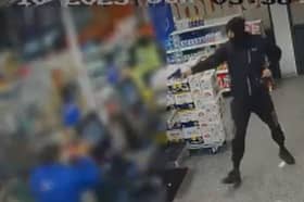 An armed robber in the Tesco store in Camden Road. (Photo by MPS)
