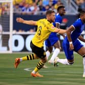 Christopher Nkunku #45 of Chelsea FC controls the ball while defended by Salih Ozcan #6 of Borussia Dortmund 