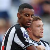 Alexander Isak of Newcastle United celebrates with team mate Kieran Trippier after scoring their sides first goal during the Premier League match 