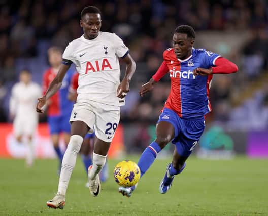 Naouirou Ahamada of Crystal Palace runs with the ball whilst under pressure by Pape Matar Sarr of Tottenham Hotspur